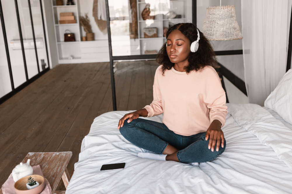 Person meditating in bed to calm the nervous system during a hypermobility flare