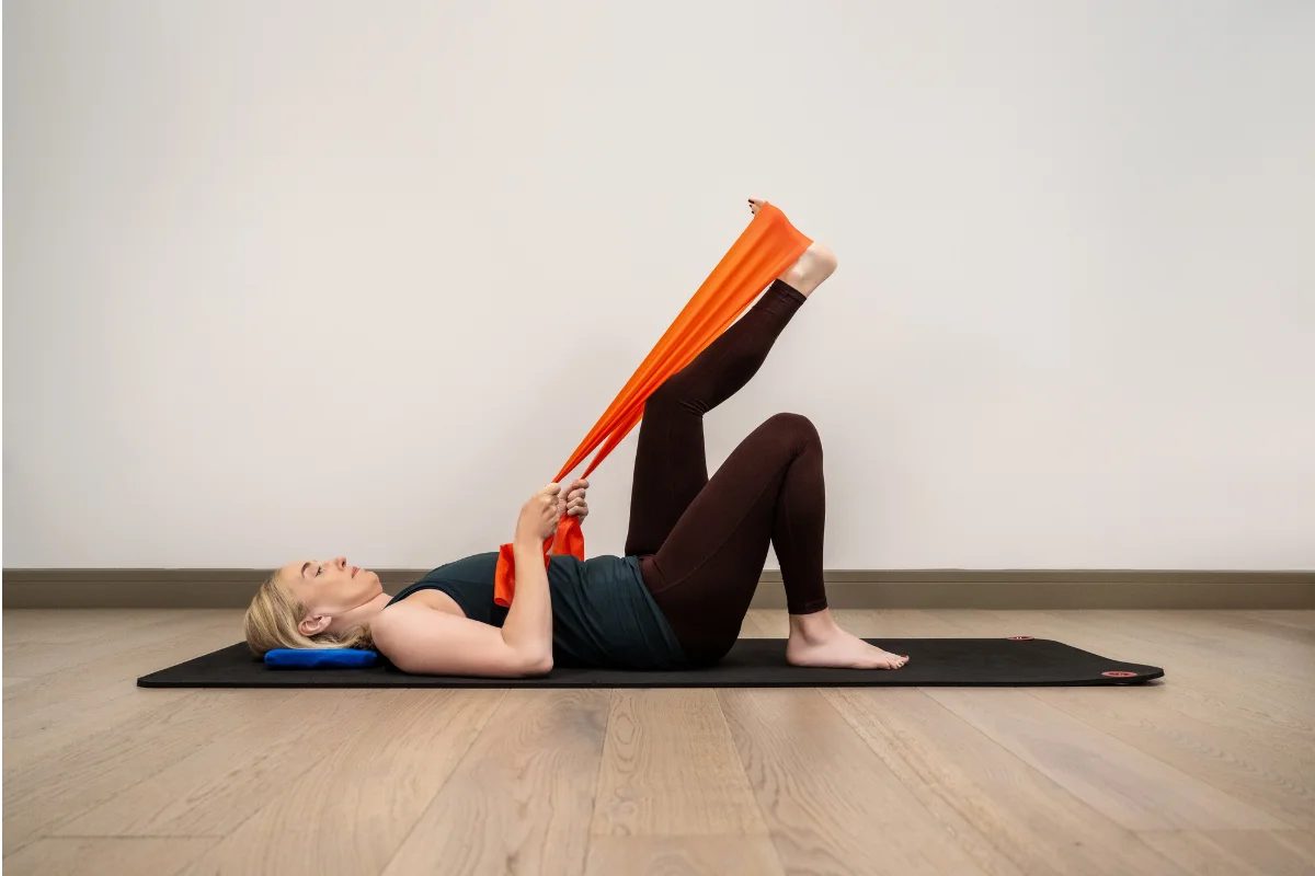 Jeannie Di Bon demonstrating a resistance band leg stretch as part of the Integral Movement Method